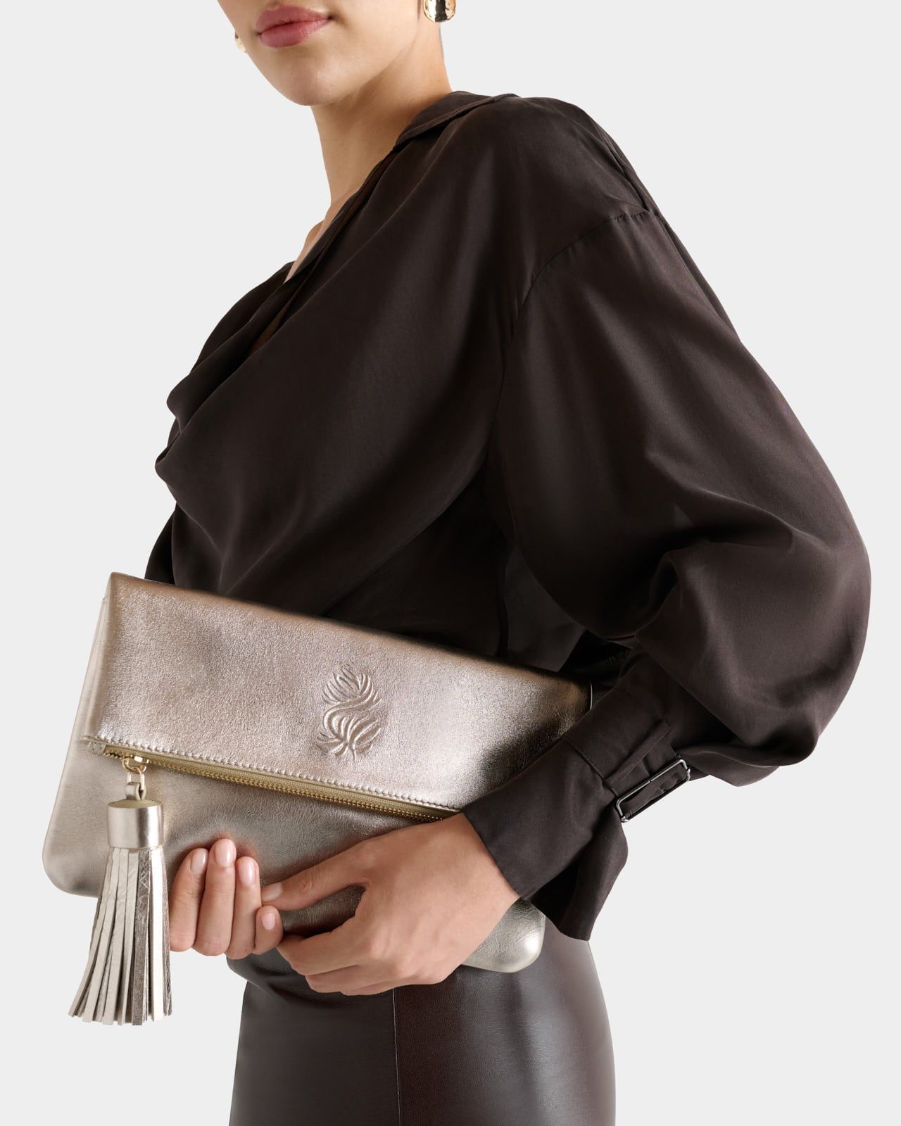 The Luxe Tassel Leather Clutch in Metallic Gold